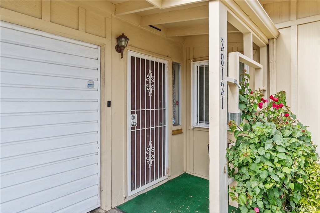 28121 Pebble Beach Drive Menifee, CA 92586 - Photo 5 of 35 a view of a door and brick walls