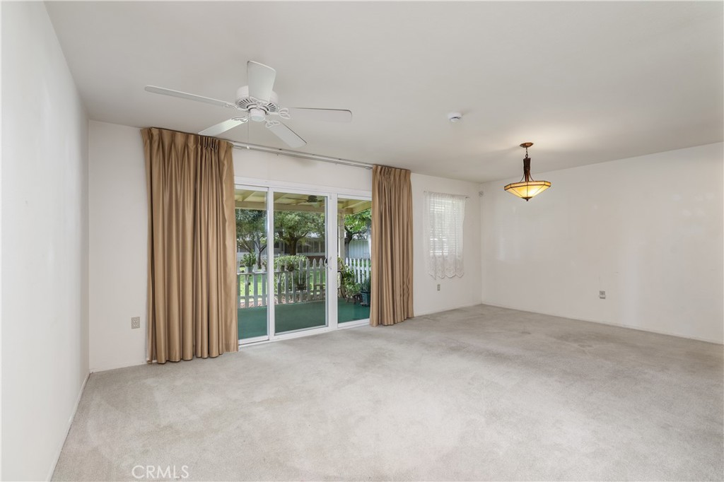 28121 Pebble Beach Drive Menifee, CA 92586 - Photo 7 of 35 en empty room with windows and ceiling fan