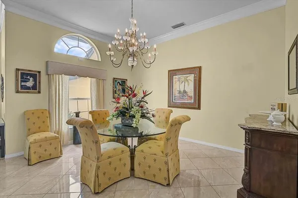 a dining room with furniture and chandelier