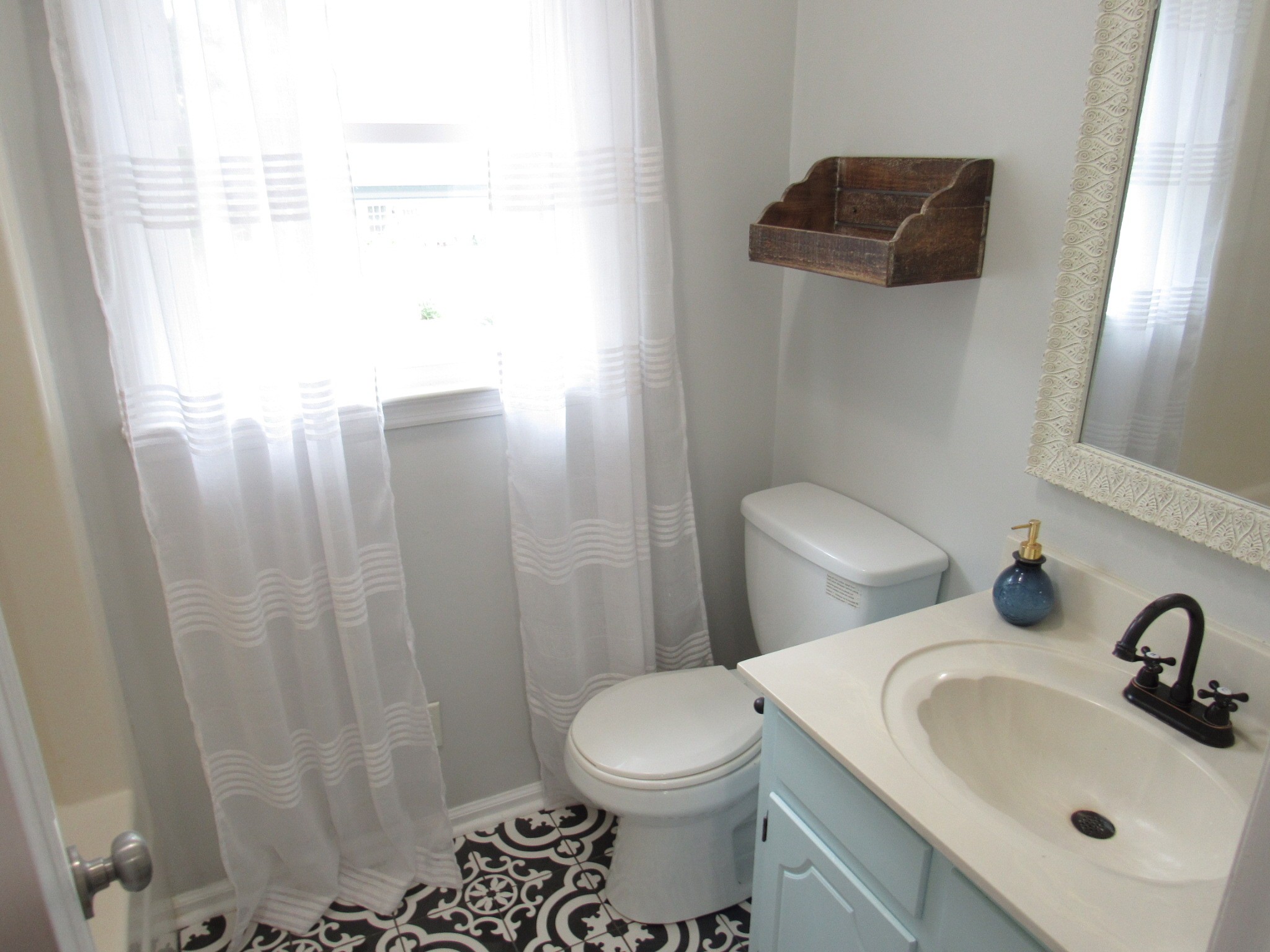 2027 Hidden Cove Road Mount Juliet, TN 37122 - Photo 21 of 25 a bathroom with a sink a toilet and shower curtain