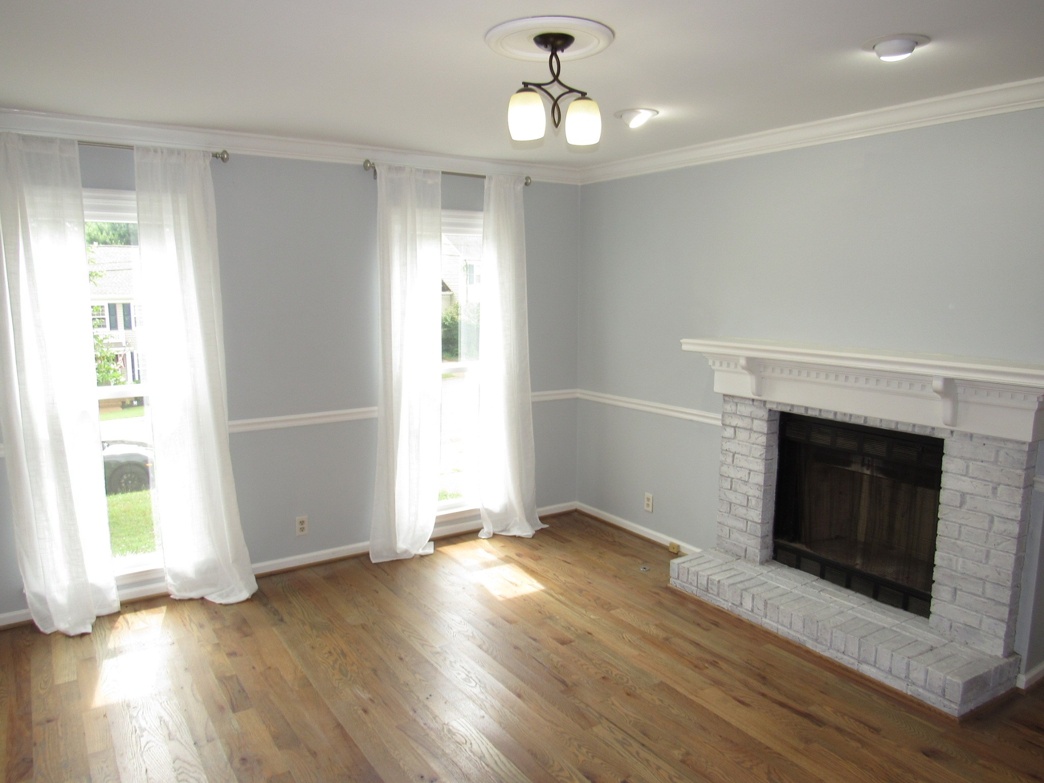 2027 Hidden Cove Road Mount Juliet, TN 37122 - Photo 6 of 25 a view of an empty room with wooden floor fireplace and a window