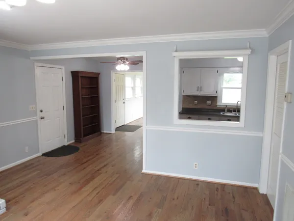 a kitchen with granite countertop a sink stove and cabinets