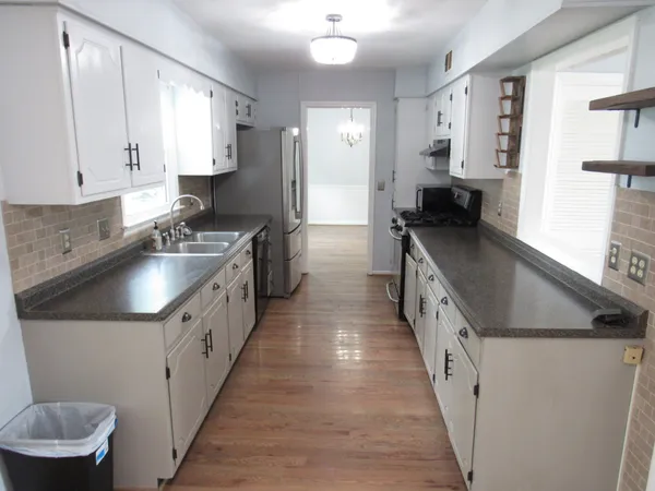 a stove top oven sitting inside of a kitchen