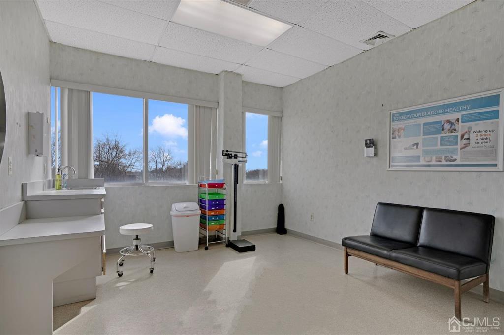 1656 Oak Tree Road, Unit 2 Edison, NJ 08820 - Photo 12 of 19 a room with furniture and a lamp