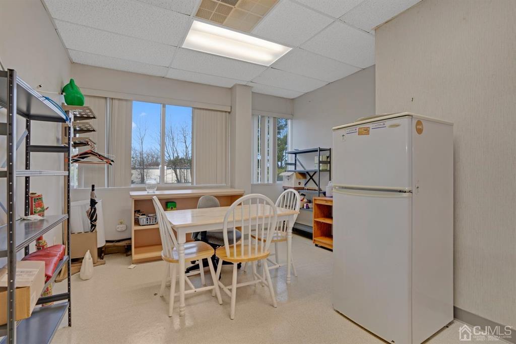 1656 Oak Tree Road, Unit 2 Edison, NJ 08820 - Photo 15 of 19 a dining room with furniture and a window