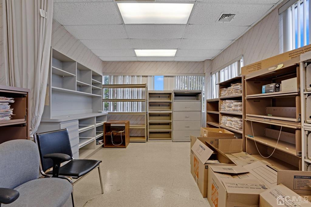 1656 Oak Tree Road, Unit 2 Edison, NJ 08820 - Photo 16 of 19 a view of walk in closet with clothes and shoes