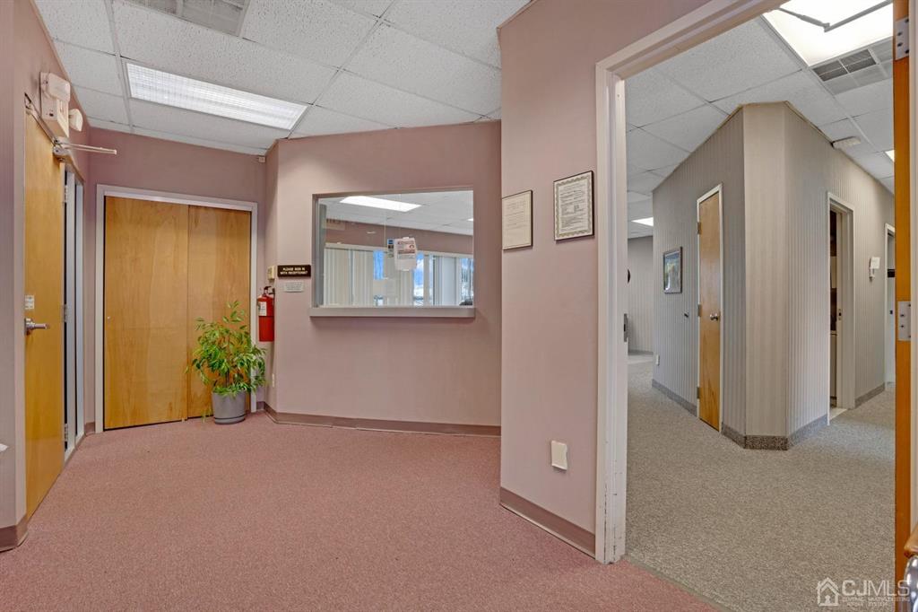 1656 Oak Tree Road, Unit 2 Edison, NJ 08820 - Photo 7 of 19 a view of a hallway with wooden shelves
