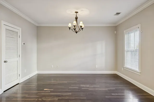a view of a room with wooden floor and a ceiling fan