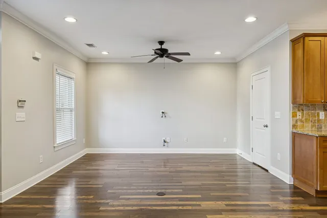 a kitchen with a refrigerator a sink and wooden cabinets