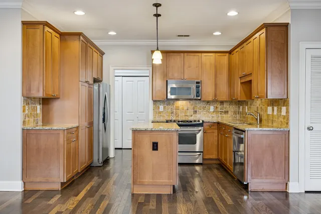 a kitchen with stainless steel appliances granite countertop a sink and a microwave