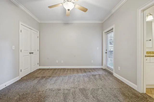 a view of an empty room with a ceiling fan
