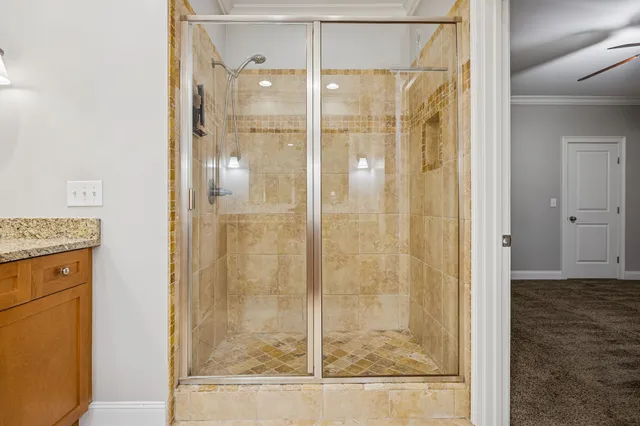a bathroom with a granite countertop sink mirror and a toilet