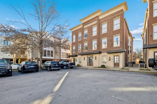 a view of large kitchen with wooden floor and windows