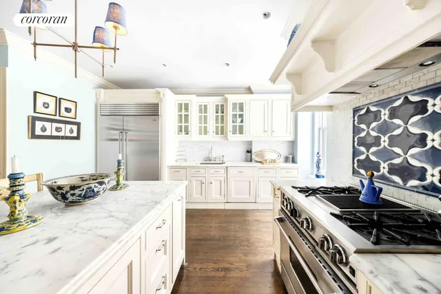 a kitchen with a stove a sink and a refrigerator