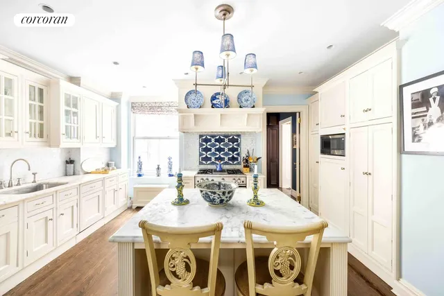 a kitchen with a dining table and chairs