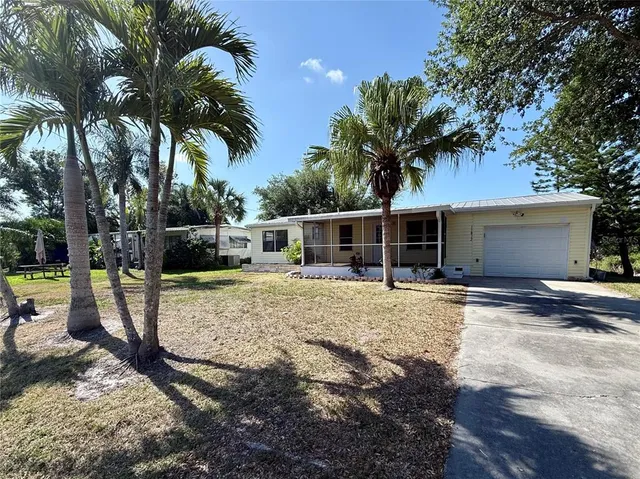 a front view of a house with garden and patio