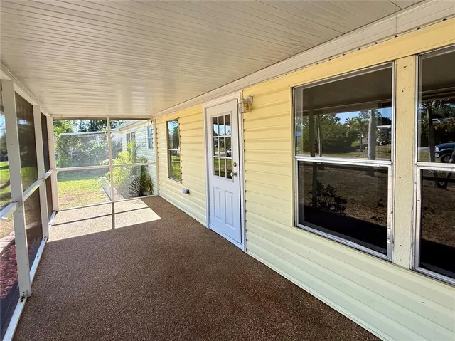 a view of an entryway with a floor to ceiling window