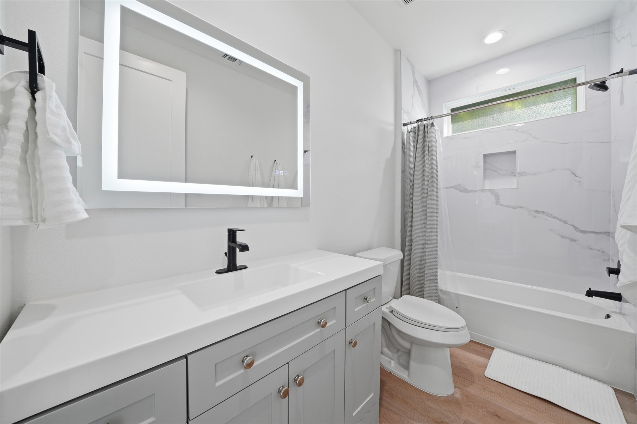 2216 Yellow Jacket Lane, Unit 2 Austin, TX 78741 - Photo 19 of 25 a bathroom with a sink a toilet and shower