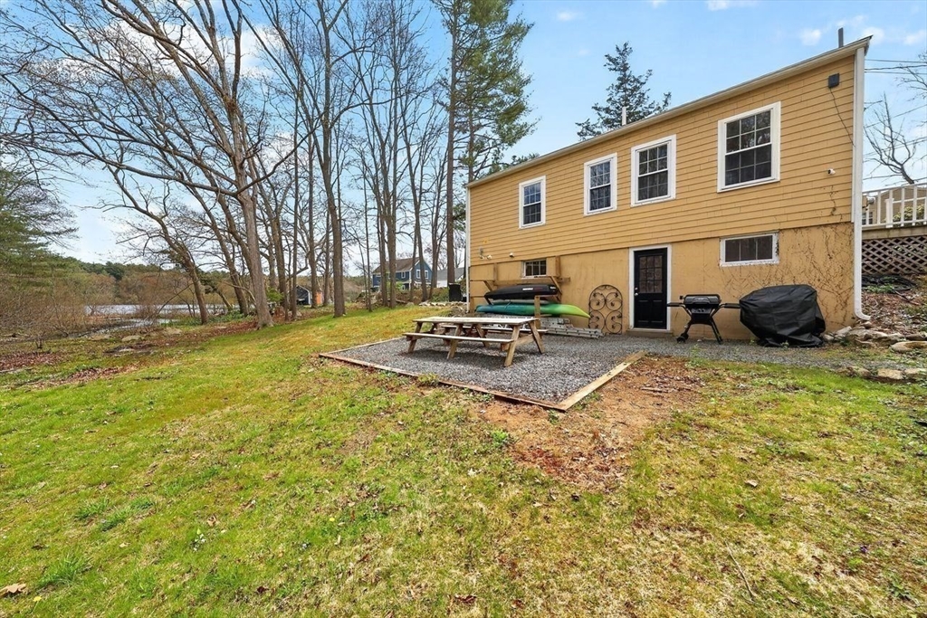 15 Leigh Road Norwell, MA 02061 - Photo 22 of 34 a backyard of a house with table and chairs