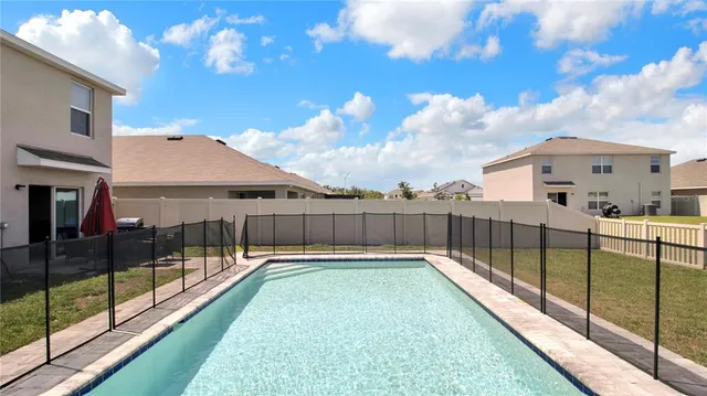 a view of a backyard with a large trees