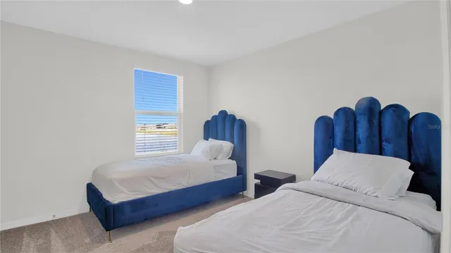 a bedroom with two beds and a dresser