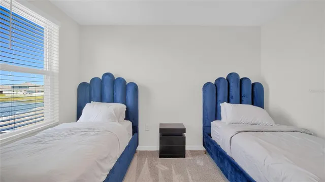 a bedroom with bed and a window