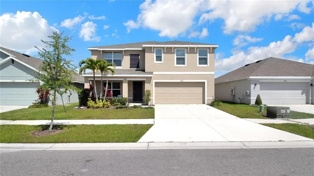 a front view of house with yard and green space