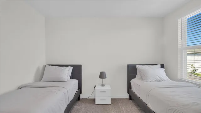 a bedroom with a bed and a night stand