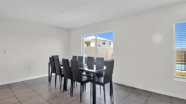 a view of a dining room with furniture and window