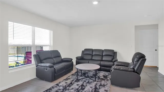 a living room with furniture lamp and window