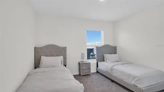 a bedroom with a bed and lamp