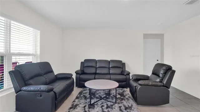a living room with furniture and a window
