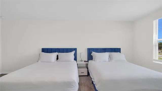 a bedroom with a bed and a night stand