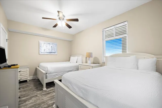 a bedroom with two beds and a chandelier