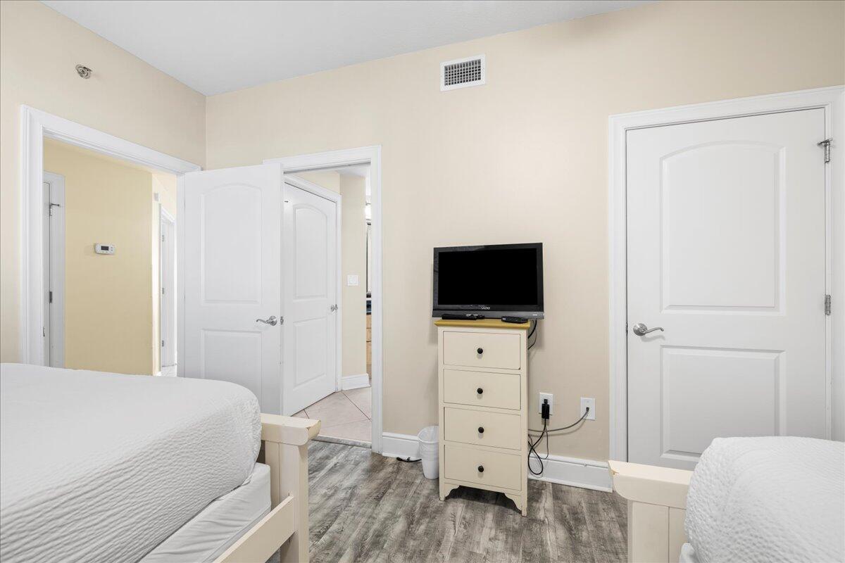 1150 Santa Rosa Boulevard, Unit 520 Fort Walton Beach, FL 32548 - Photo 16 of 25 a bedroom with a bed and a flat tv screen on dresser