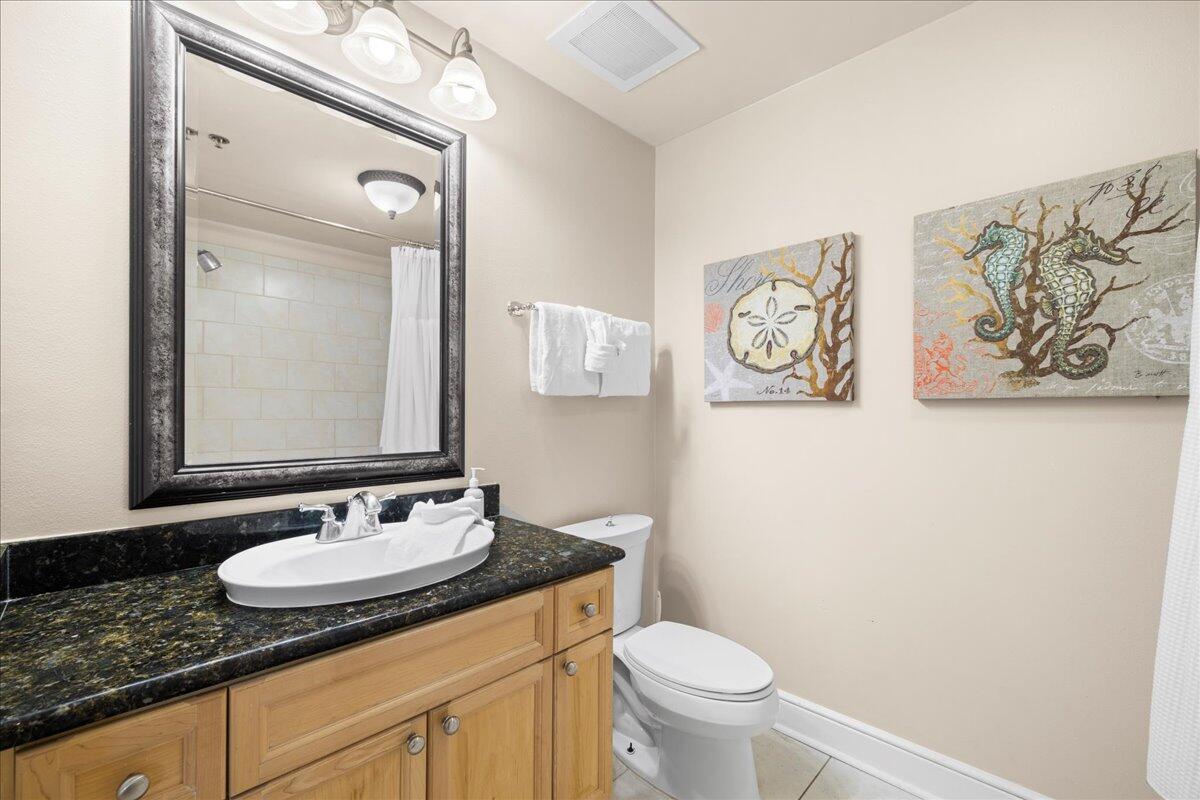 1150 Santa Rosa Boulevard, Unit 520 Fort Walton Beach, FL 32548 - Photo 17 of 25 a bathroom with a granite countertop sink toilet and a mirror