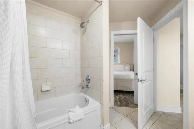 a bathroom with a tub a sink and a shower