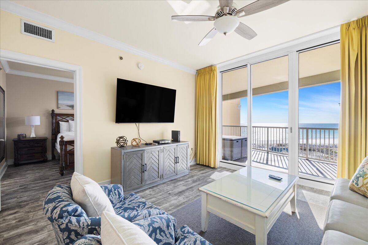 1150 Santa Rosa Boulevard, Unit 520 Fort Walton Beach, FL 32548 - Photo 7 of 25 a living room with furniture a flat screen tv and a large window