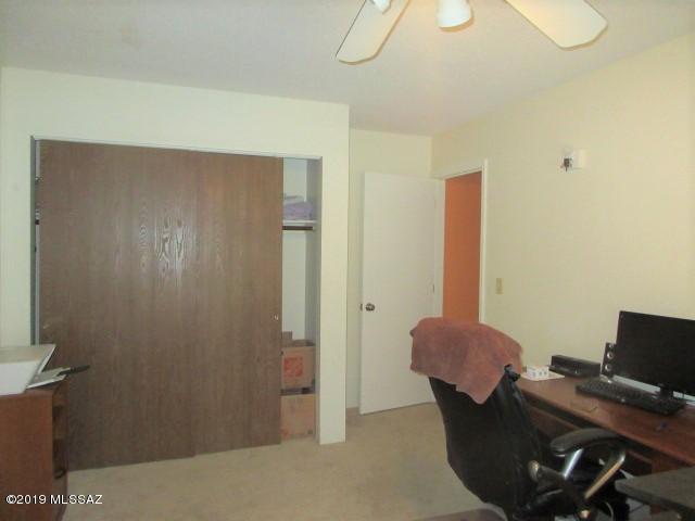 1022 Via Independencia Rio Rico, AZ 85648 - Photo 26 of 41 a workspace with furniture and lamp