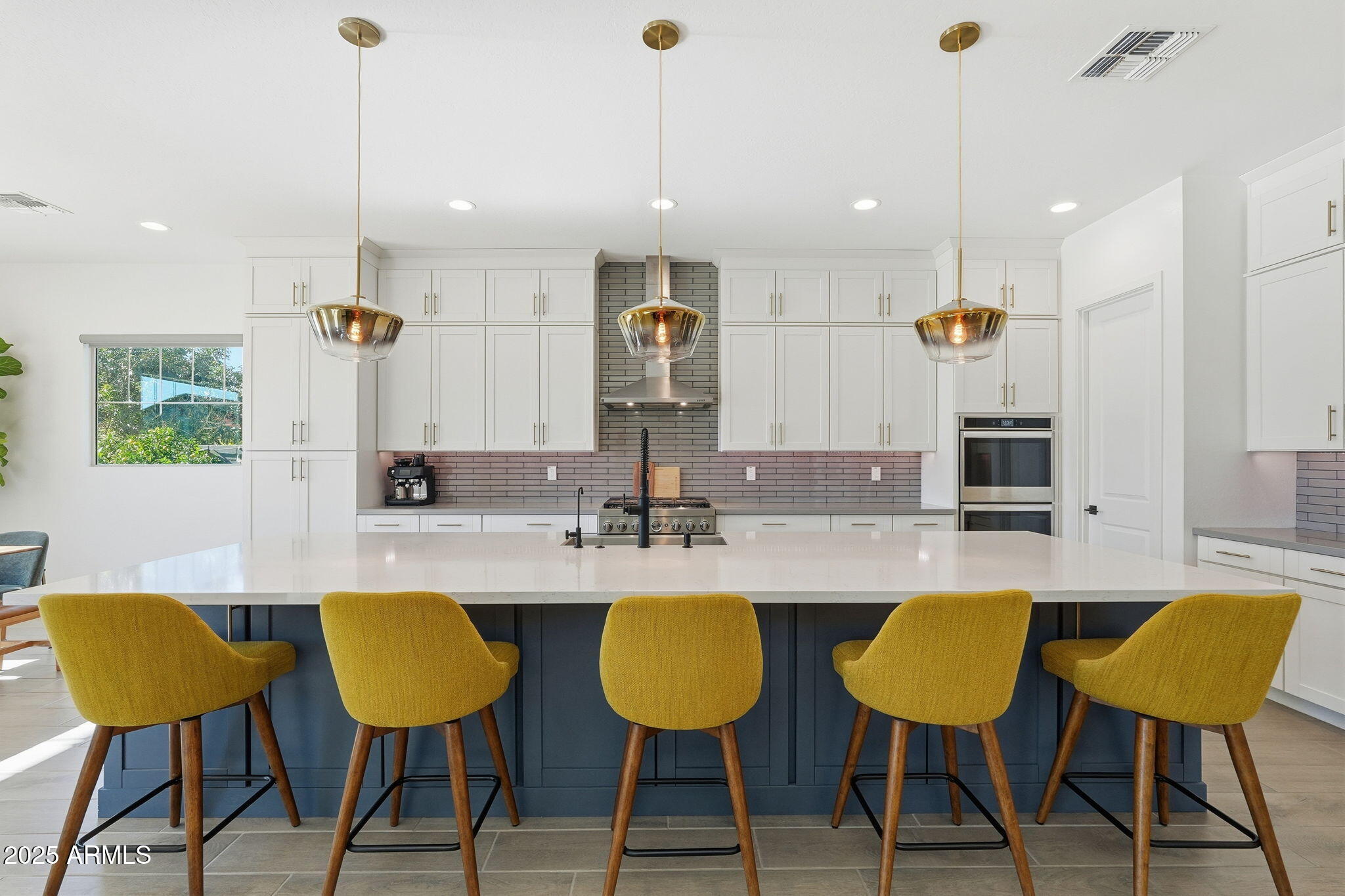22679 East Russet Road Queen Creek, AZ 85142 - Photo 16 of 51 a kitchen with stainless steel appliances kitchen island granite countertop a table chairs and a refrigerator