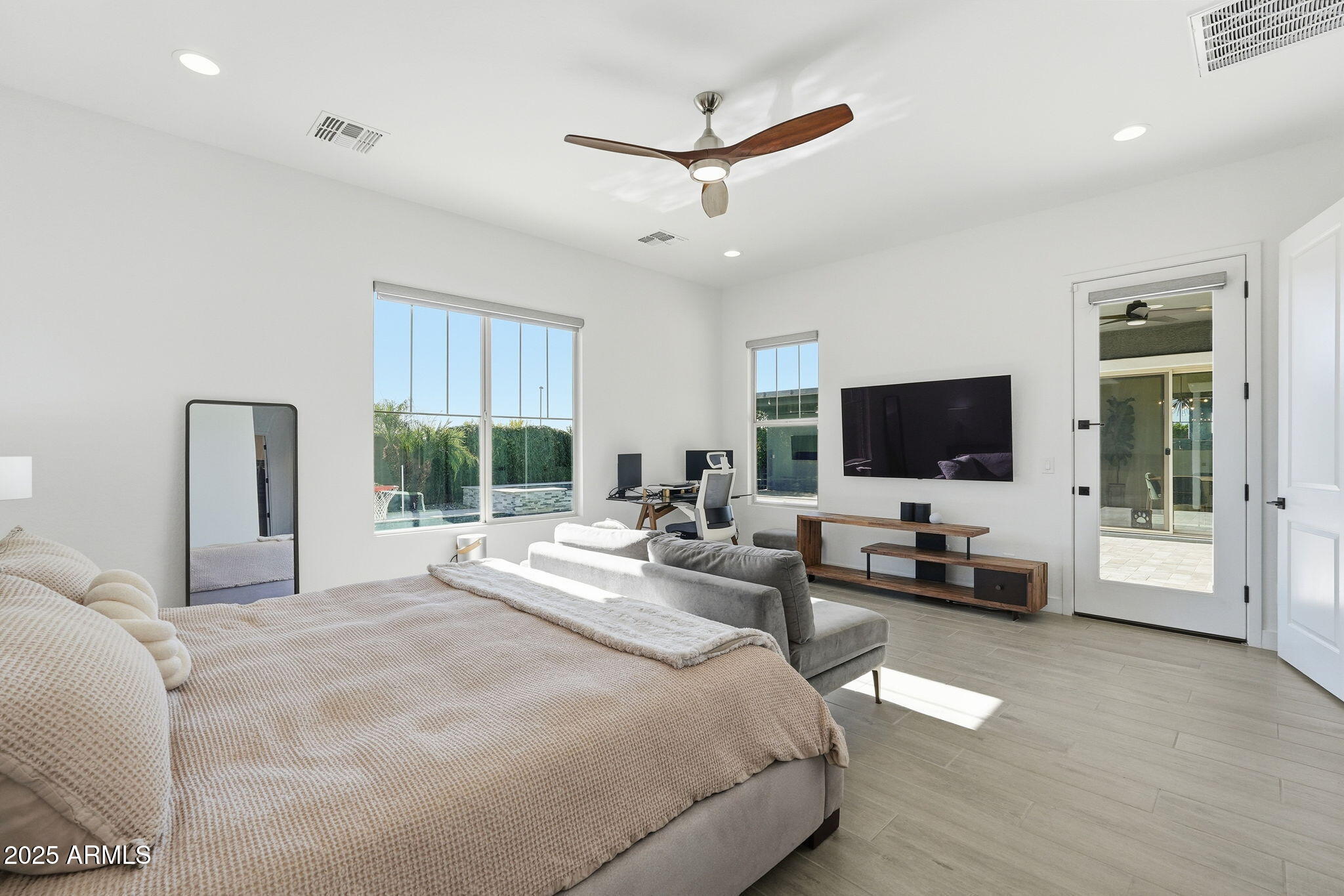 22679 East Russet Road Queen Creek, AZ 85142 - Photo 25 of 51 a bedroom with a bed a large window and a flat screen tv