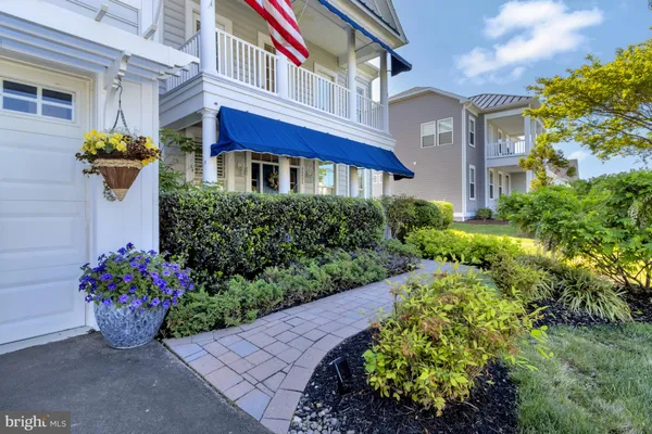 a kitchen with kitchen island wooden cabinets and refrigerator