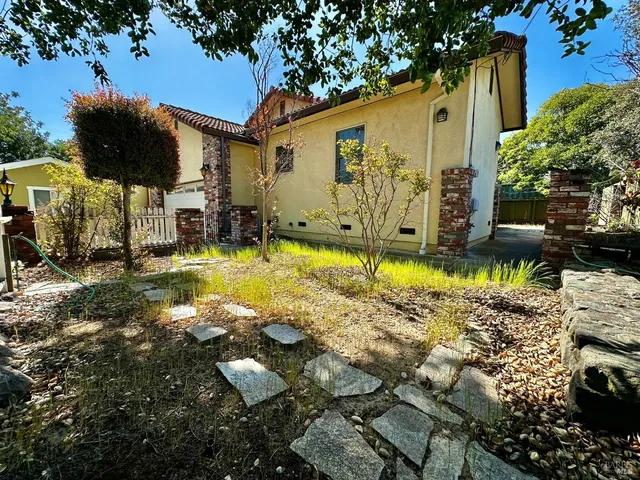 wooden floor fireplace and windows in an empty room