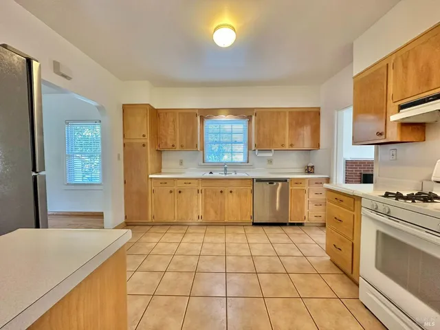 a view of an empty room with a fireplace