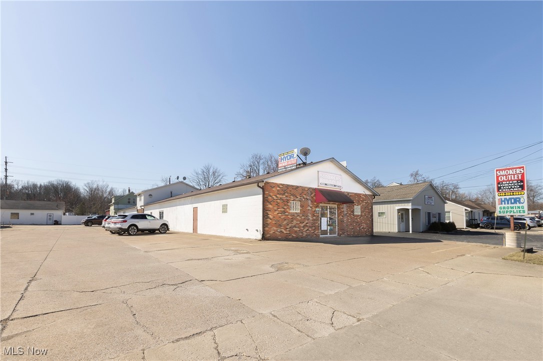 41957 North Ridge Road Elyria, OH 44035 - Photo 18 of 29 View of front facade with brick siding and uncovered parking