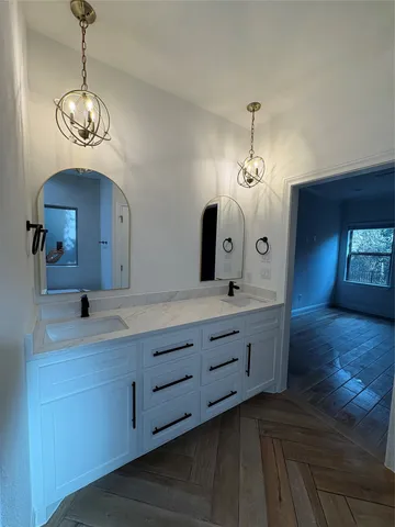 a bathroom with a sink a toilet and a mirror