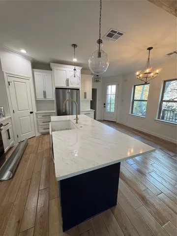 an open kitchen with a table and chairs in it