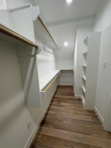 a spacious bathroom with double vanity and a mirror