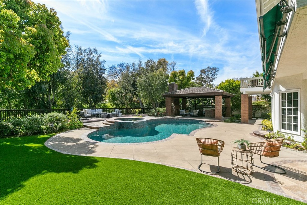 a view of a backyard with sitting area