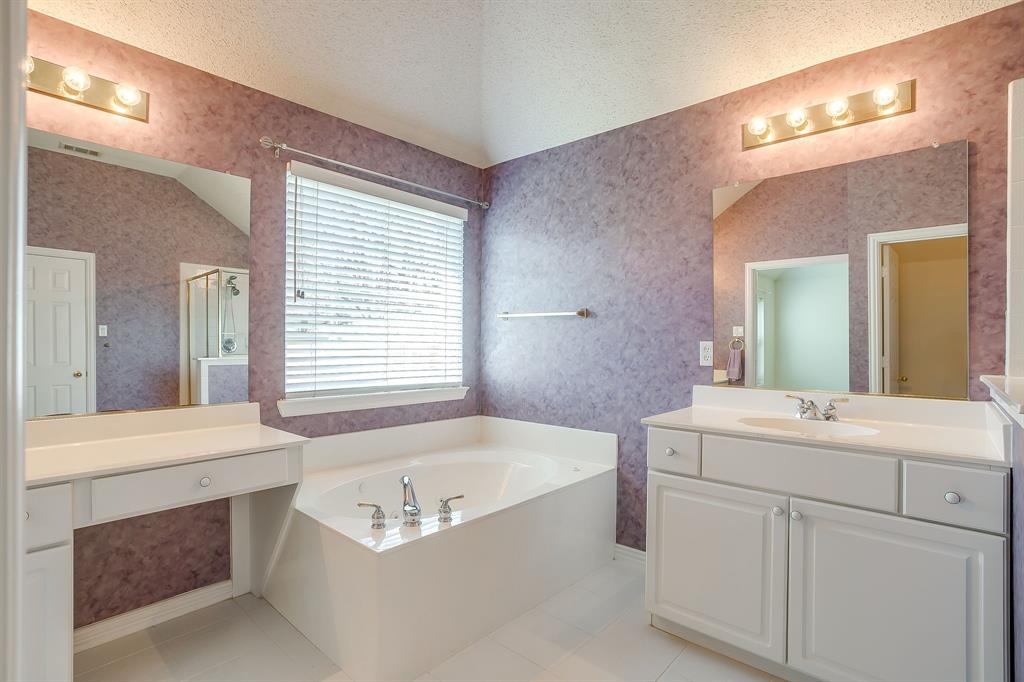 8105 Hosta Way Fort Worth, TX 76123 - Photo 26 of 33 a bathroom with a tub a sink and a mirror